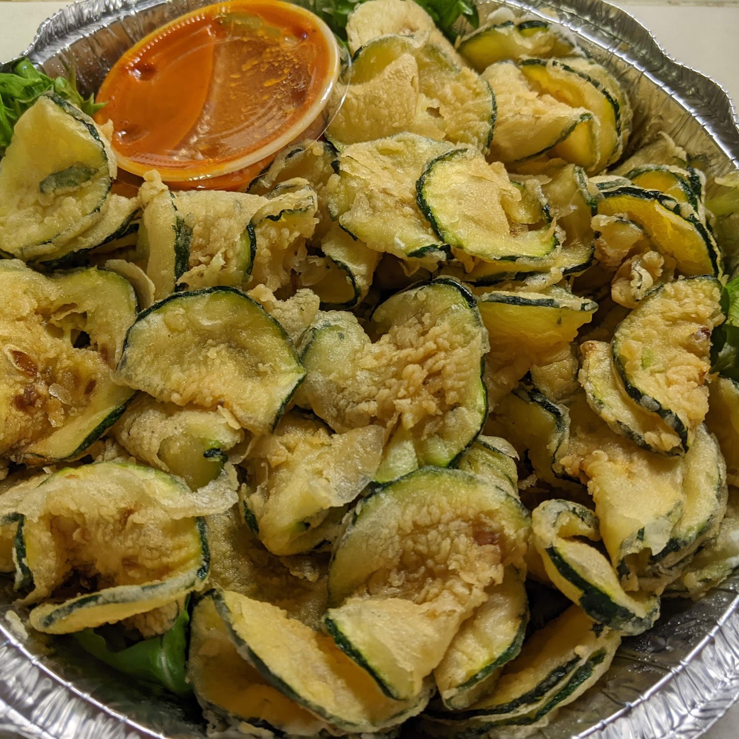 Fried zucchini with house red sauce — Italian appetizer at El Torito Deli